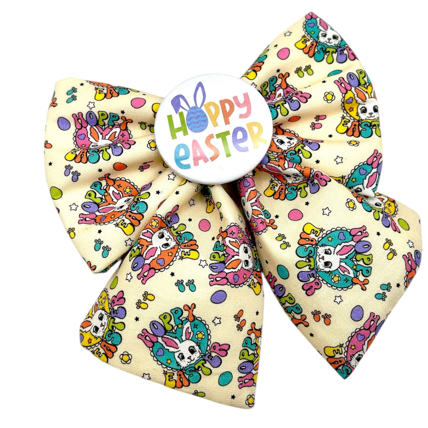 Easter sailor bow for dogs. Cream bow with Hoppy Easter written across the bow, with a bunny. Colourful and fun lettering. Colourful badge in the middle that reads " HOPPY EASTER"