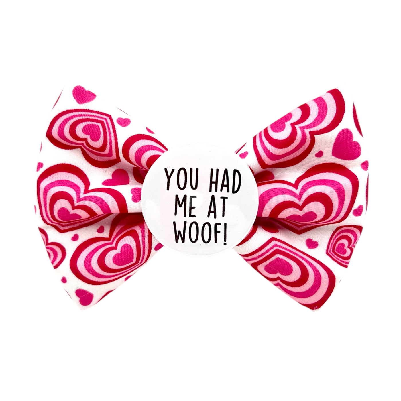 Pet bow tie Valentine's day. white bow with large pink hearts. Badge in the middle with " YOU HAD ME AT WOOF" text