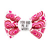 Pet bow tie Valentine's day. white bow with large pink hearts. Badge in the middle with " YOU HAD ME AT WOOF" text