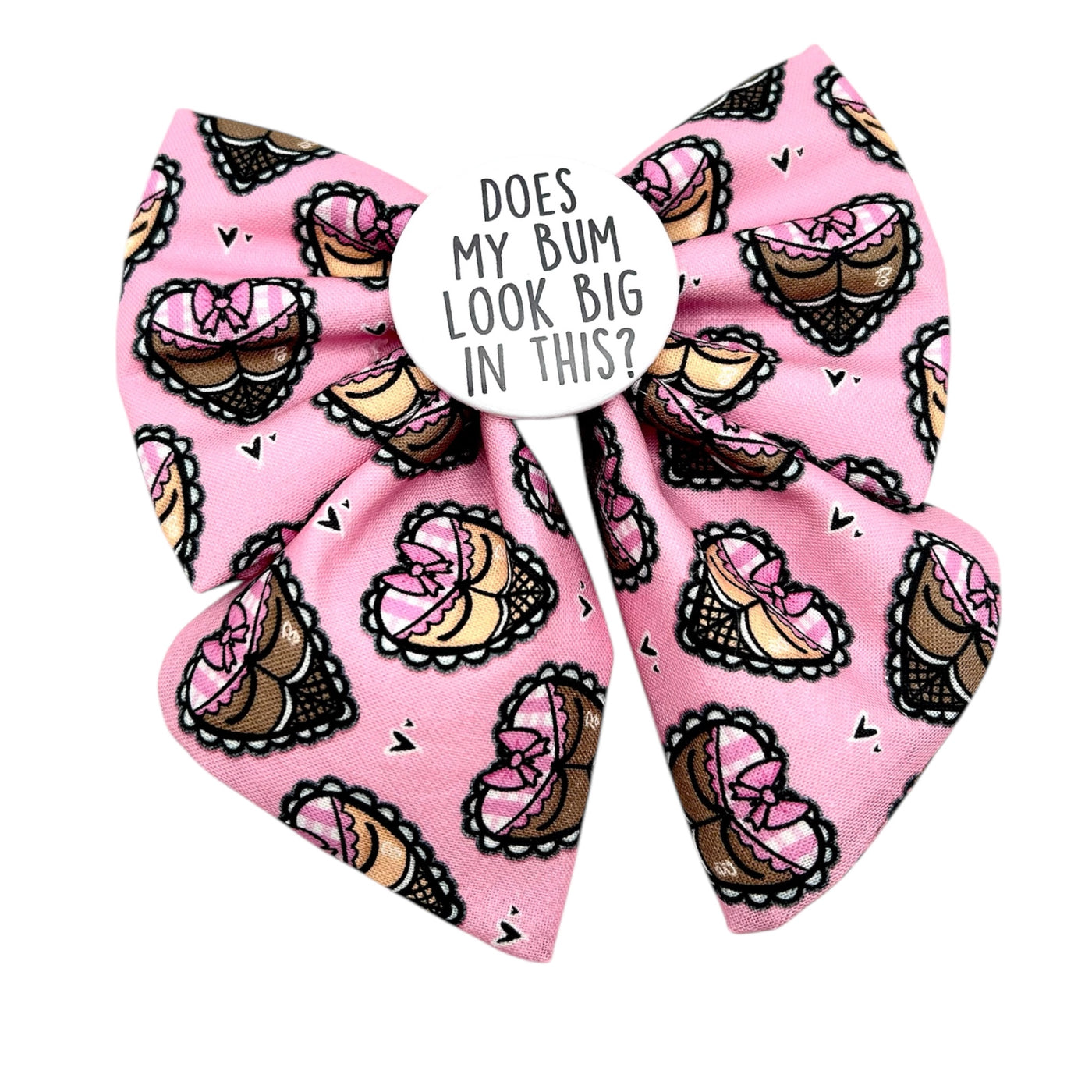 Cheeky Valentine's Sailor bow for dogs. Pink bow with cheeky bottoms in the shape of hearts. Badge in the middle that says " Does my bum look big in this?"