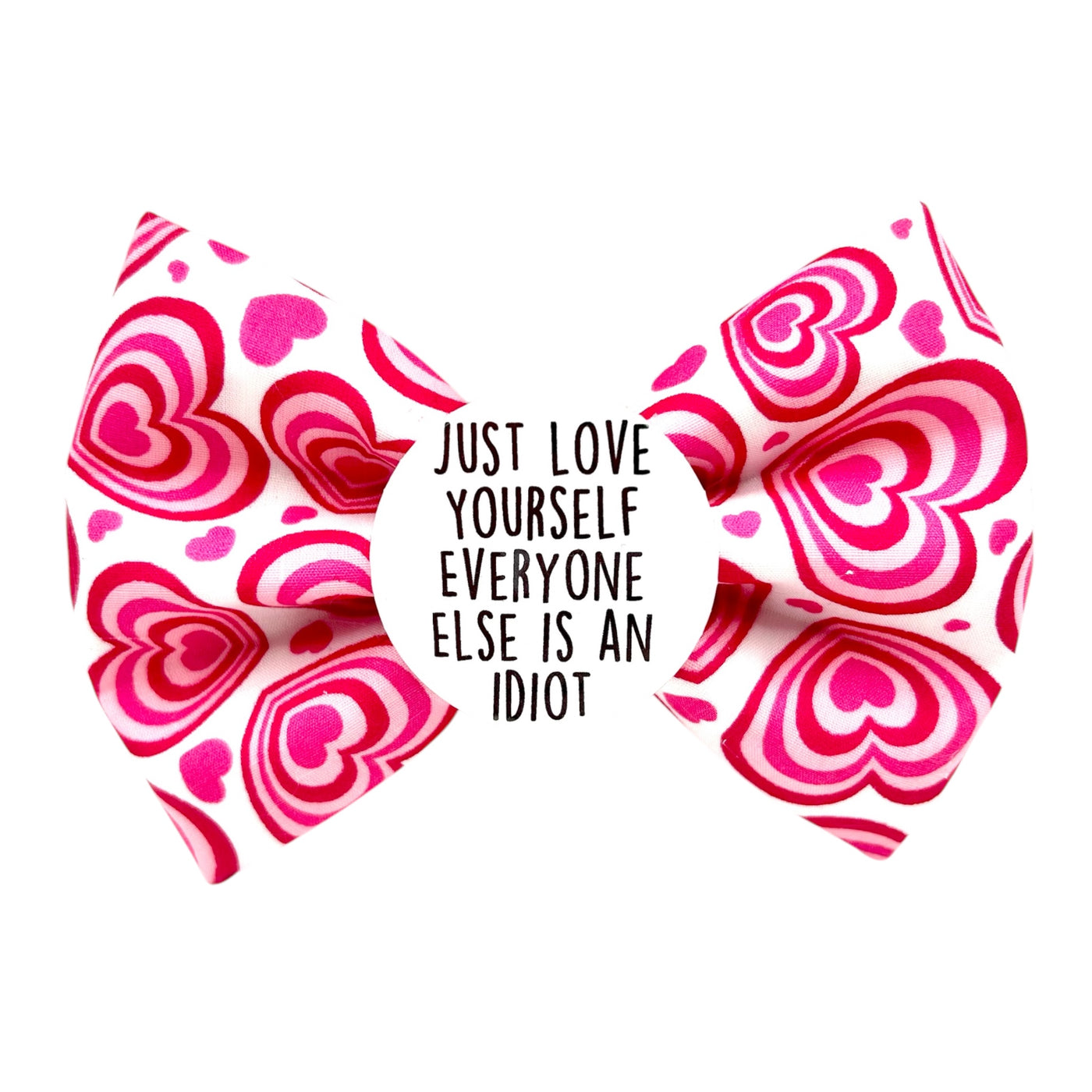 Valentine's pet bow tie. White bow with pink hearts across. Badge in the middle that says " JUST LOVE YOURSELF EVERYONE ELSE IS AN IDIOT"