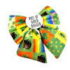 St Patricks themed sailor bow for pets. Colourful print. Orange, green, rainbows. With Pots of gold and glovers. Badge in the middle that reads " Pot O' Gold Digger"