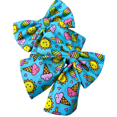 Sailor bow for dogs. Blue colour, Summer vibes. Has Sun, ice cream and ice lolly repeat pattern. Choice of badge is optional. 