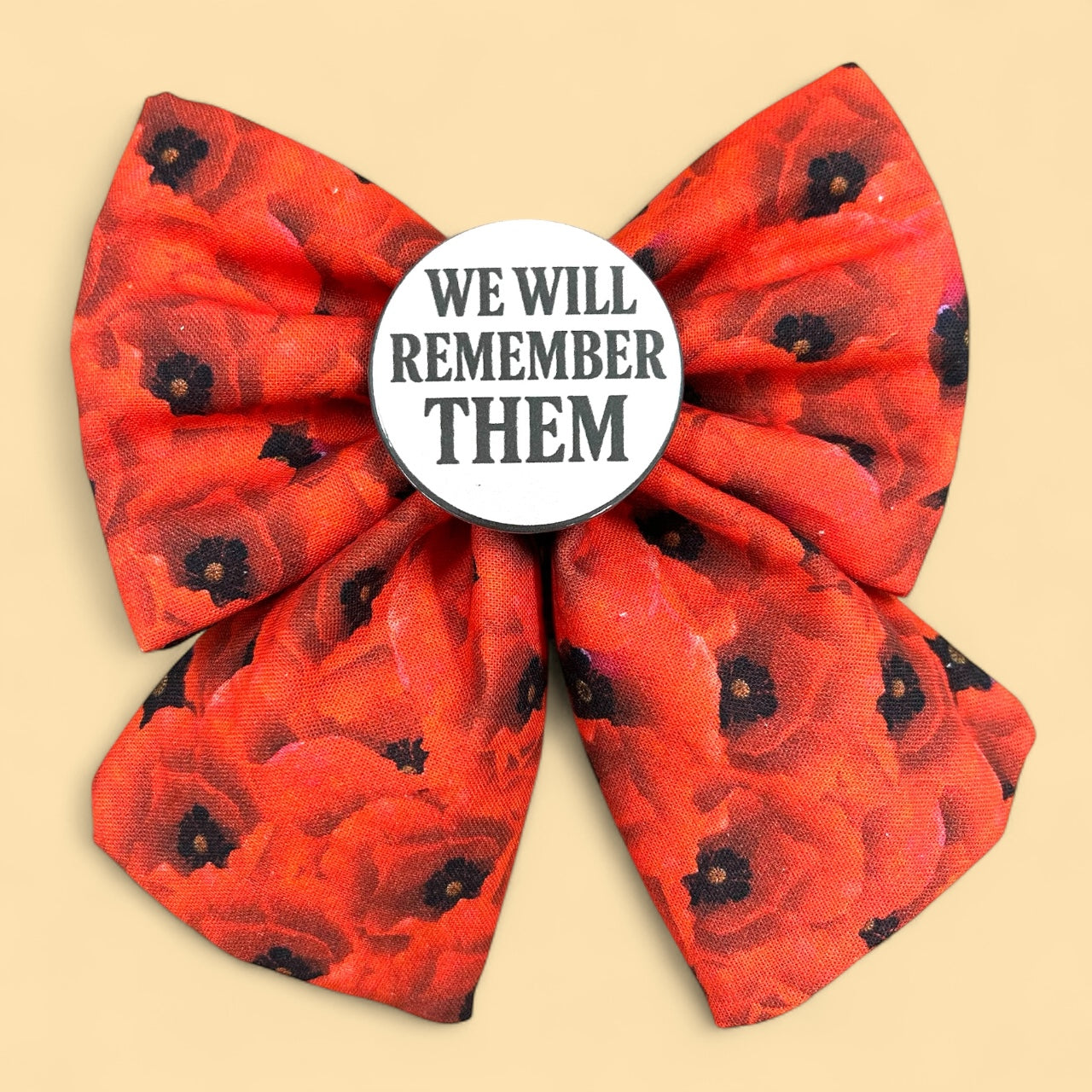 Red poppy print Sailor bow for dogs. Badge in the middle  that reads "We will remember them" A pet bow tie for remembrance Sunday. 