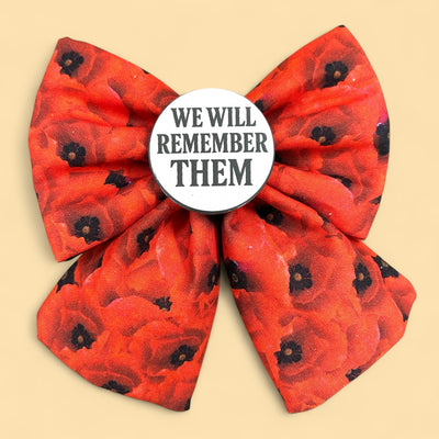 Red poppy print Sailor bow for dogs. Badge in the middle  that reads "We will remember them" A pet bow tie for remembrance Sunday. 