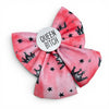 A pink watercolor sailor how for dogs, featuring black crown and star patterns, with a white circular badge that reads 'QUEEN BITCH' in black text, shown on a plain white background.