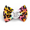 Colorful dog bow tie with a humorous message on a white background