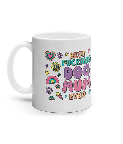 Dog Mum themed mud. 10oz. White mug with colour images all over. Hearts, rainbows, flowers. Lots of colours - Pink, purple, orange, green, yellow. Has in large print "Best Fu*king dog Mum Ever" printed on both sides of the mug