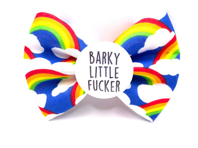 dog bow tie - Royal Blue colour, with rainbows and clouds pattern all over. Sweary/Profanity themed. Has slogan "Barky little Fu*Ker" on  a badge in the middle of it